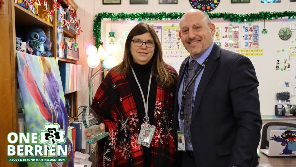 Assistant Superintendent Mr. Yauchstetter presents award to Mrs. Thomas at Sylvester Elementary.